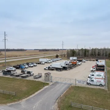 Commercial vehicles stored in a secure gated lot