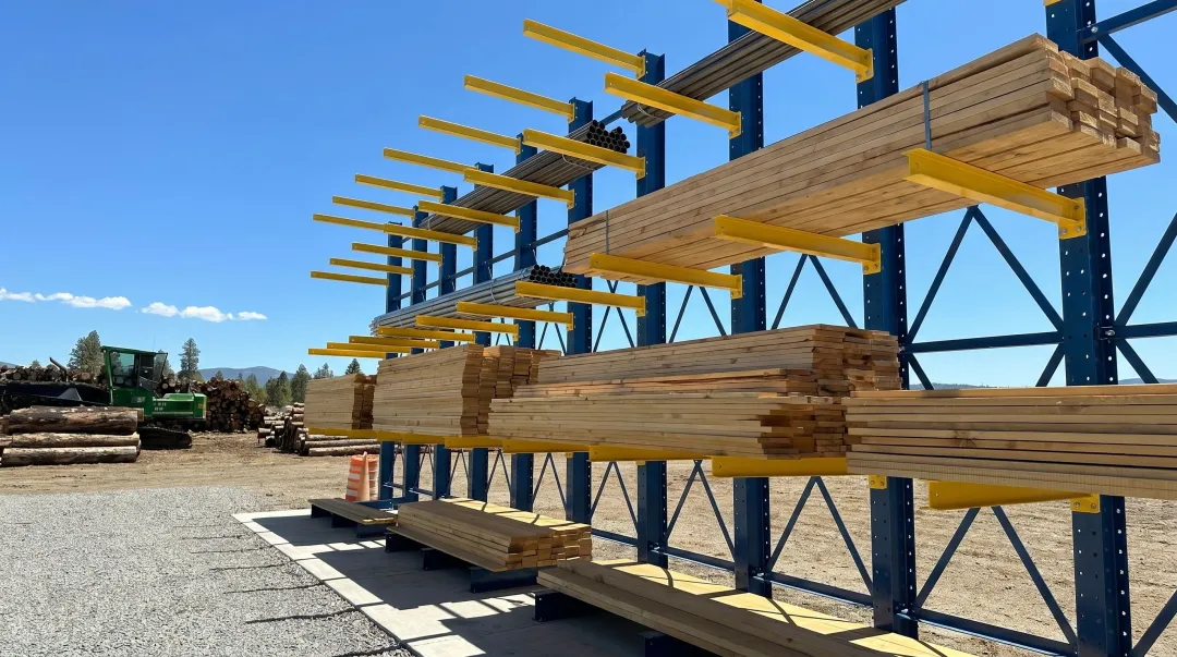 Outdoor galvanized cantilever racking system storing lumber in yard environment