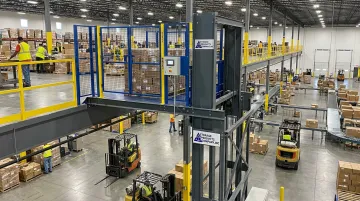 Pflow Industries VRC material lift installed on warehouse mezzanine level