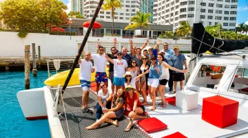 Private party boat charter cruising Miami coastline with group of guests