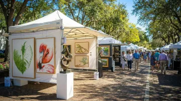 Las Olas Art Fair outdoor festival with artist booths lining tree-lined boulevard