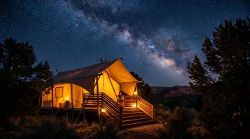 Luxury safari glamping tent under dark Arizona night sky near Grand Canyon
