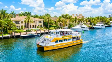 Fort Lauderdale Water Taxi navigating Intracoastal Waterway past luxury canal homes