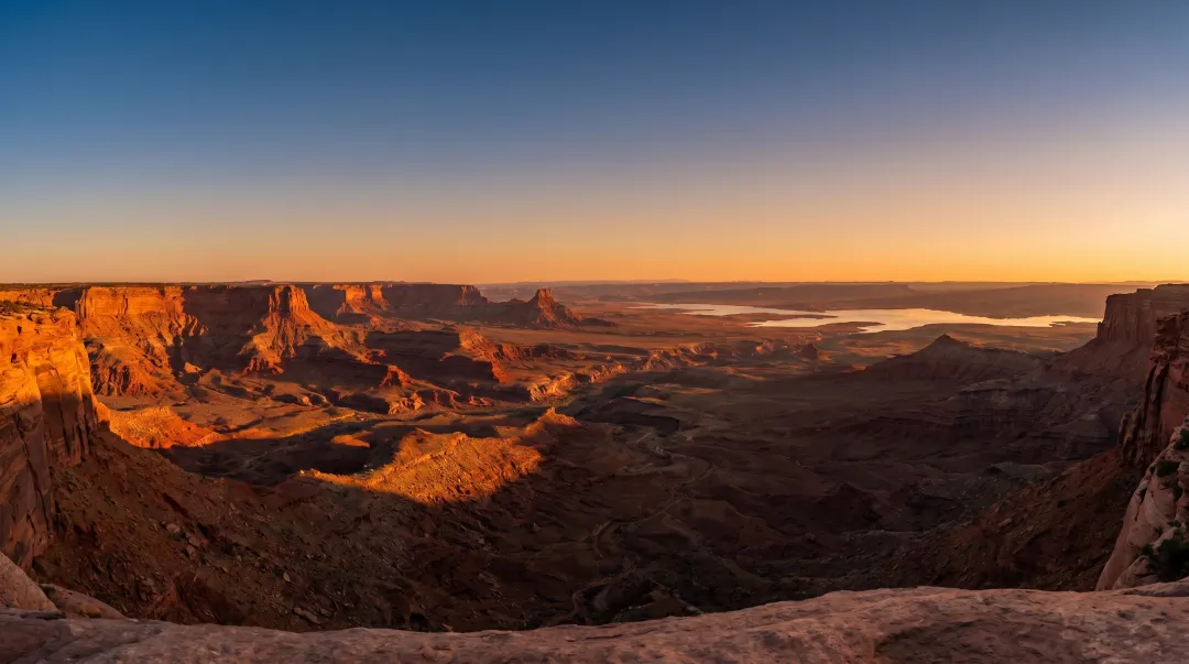 Panoramic Sedona red rock valley view from flat mesa summit at sunrise