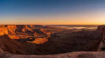 Panoramic Sedona red rock valley view from flat mesa summit at sunrise