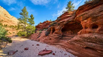 Sedona sandstone trail with cave formation and rocky desert terrain