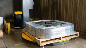 Blown stretch wrap securing heavy industrial pallet load with sharp edges