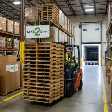 Forklift moving wood pallets in a warehouse