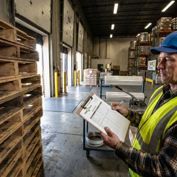 Warehouse staff reviewing pallet specifications