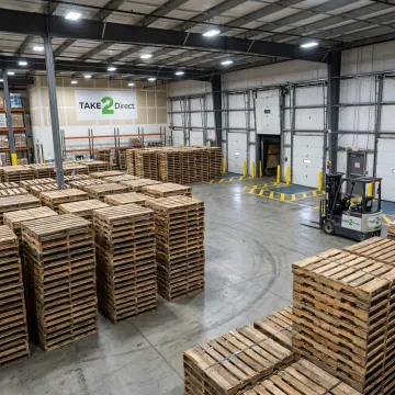 Stacked recycled pallets in a warehouse
