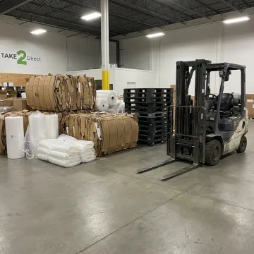 Baled cardboard and plastic recycling materials at a retail warehouse