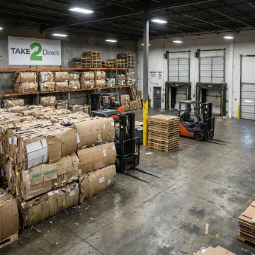 Baled cardboard ready for recycling in a warehouse