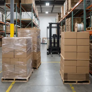 Reusable pallet wrap covers on warehouse pallets
