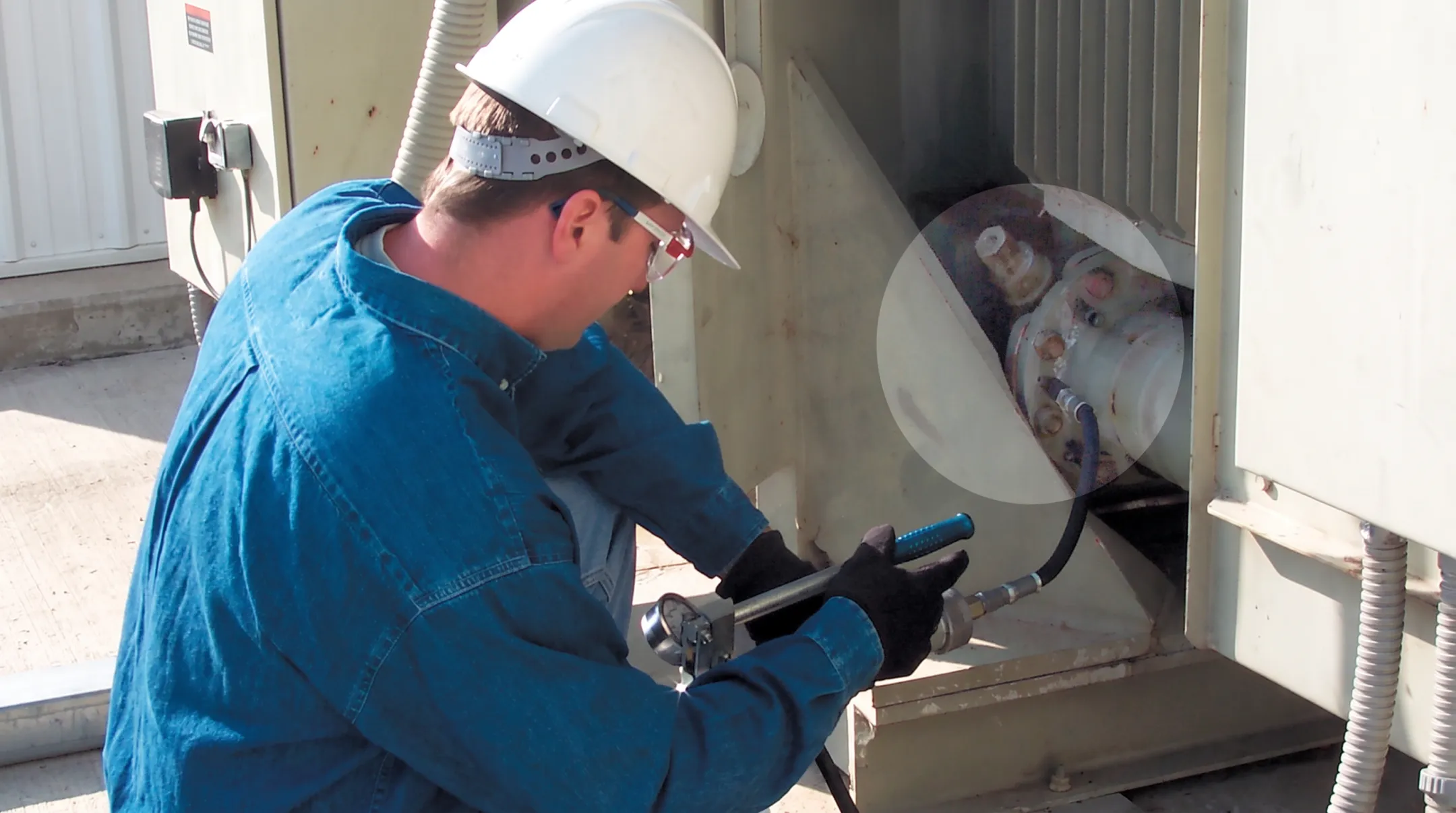 Technicians performing low-pressure transformer bushing flange leak sealing