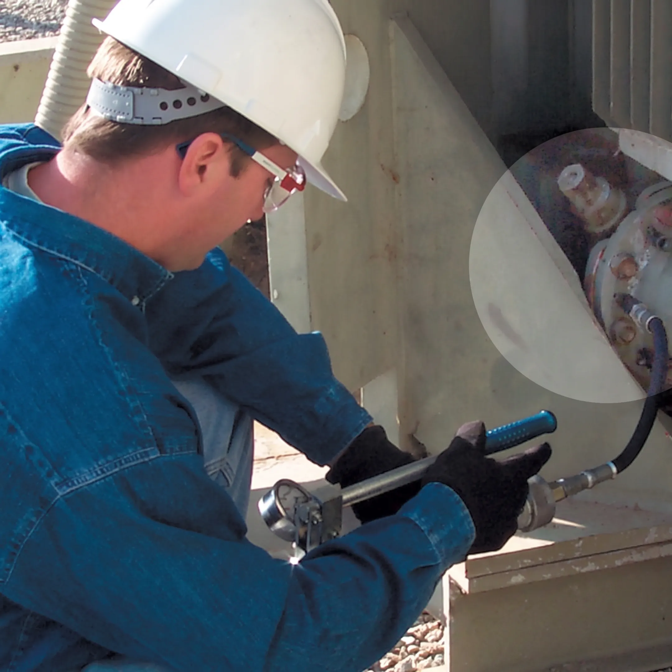Technician sealing a transformer oil leak at a substation