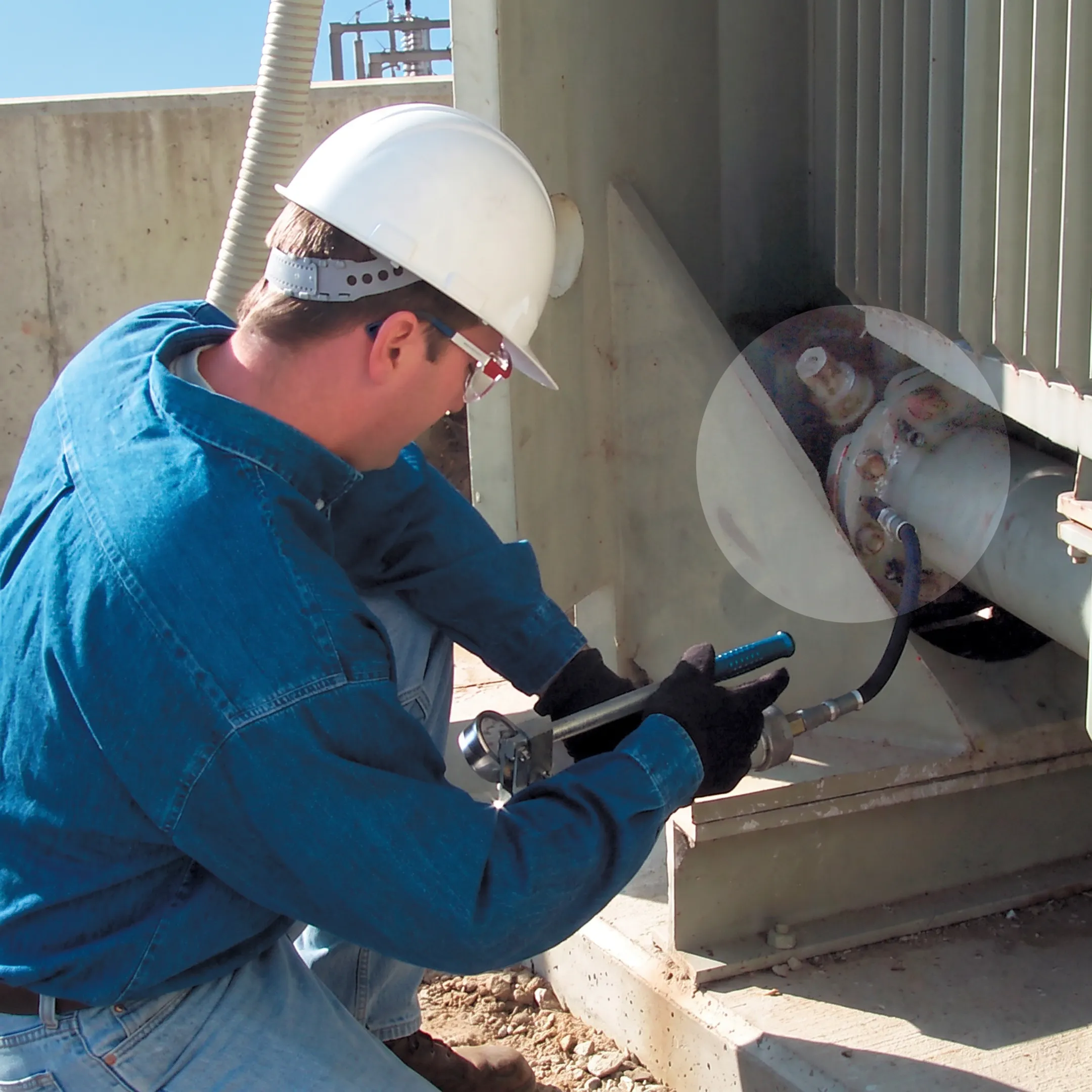 Technician inspecting a transformer leak during an online repair