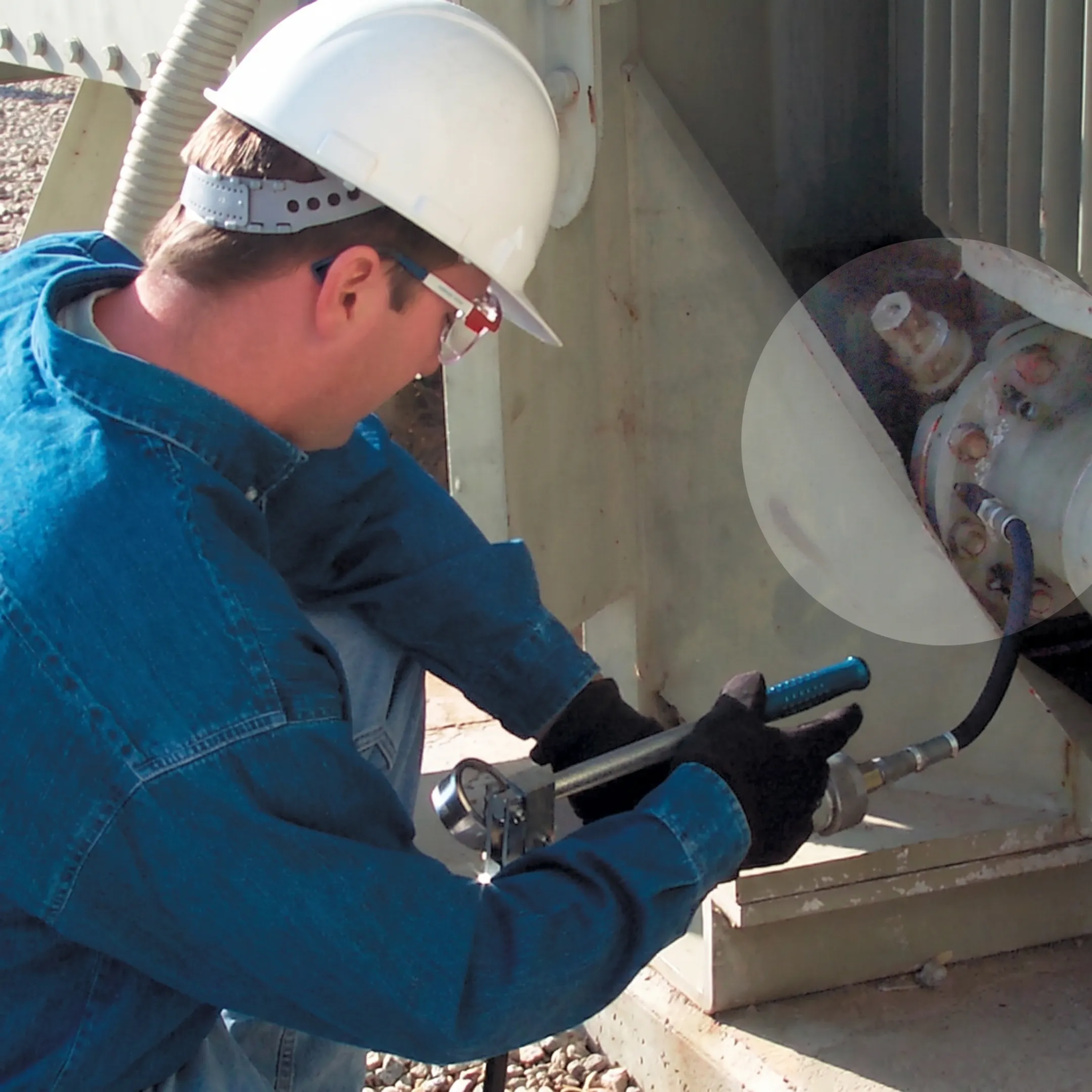 Technician sealing a transformer leak at a substation