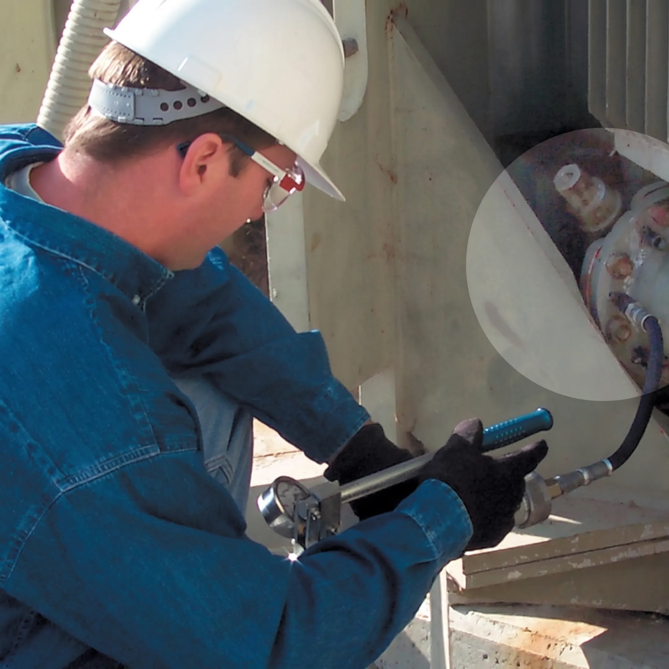 Technician sealing a transformer oil leak at a substation