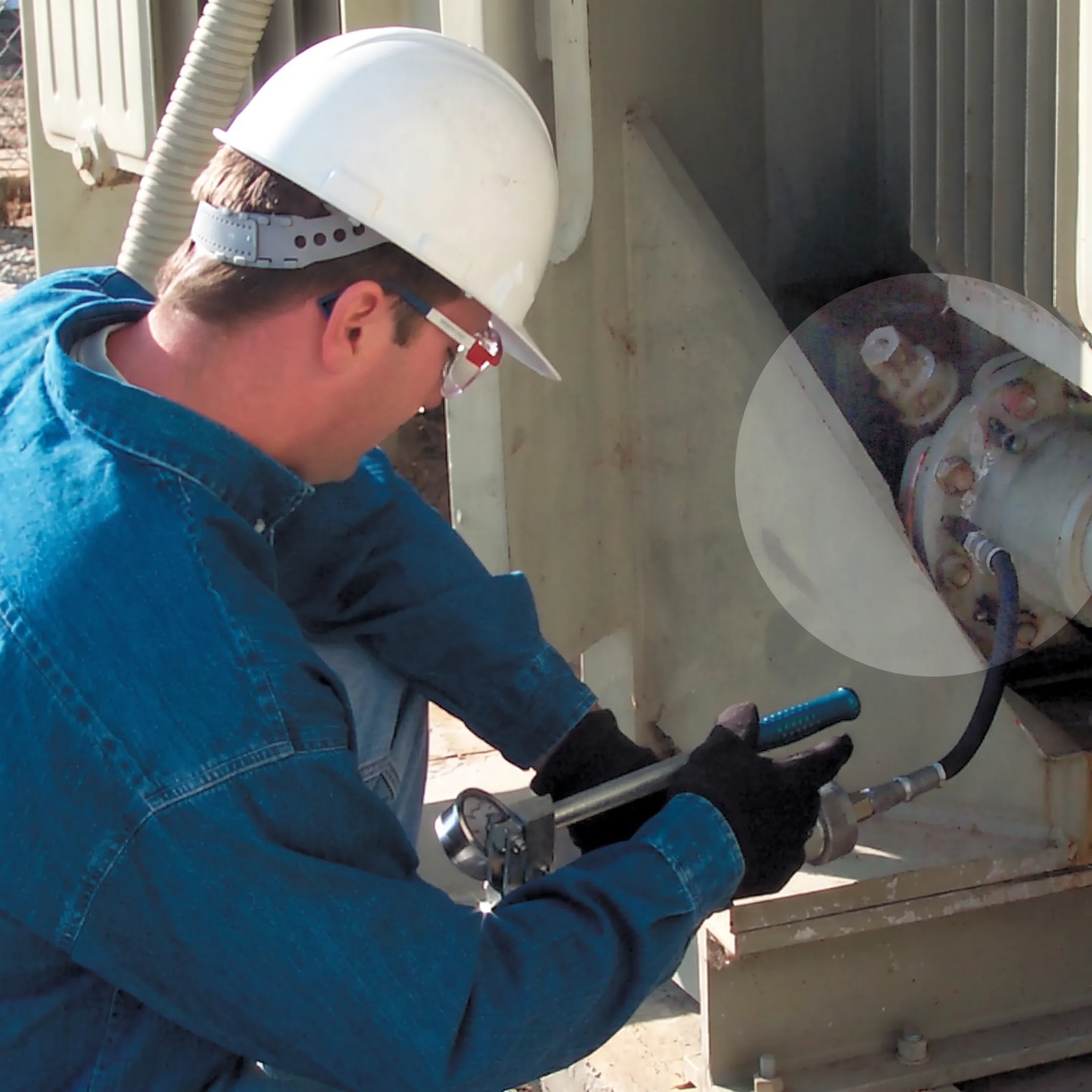 Technician performing online transformer leak sealing