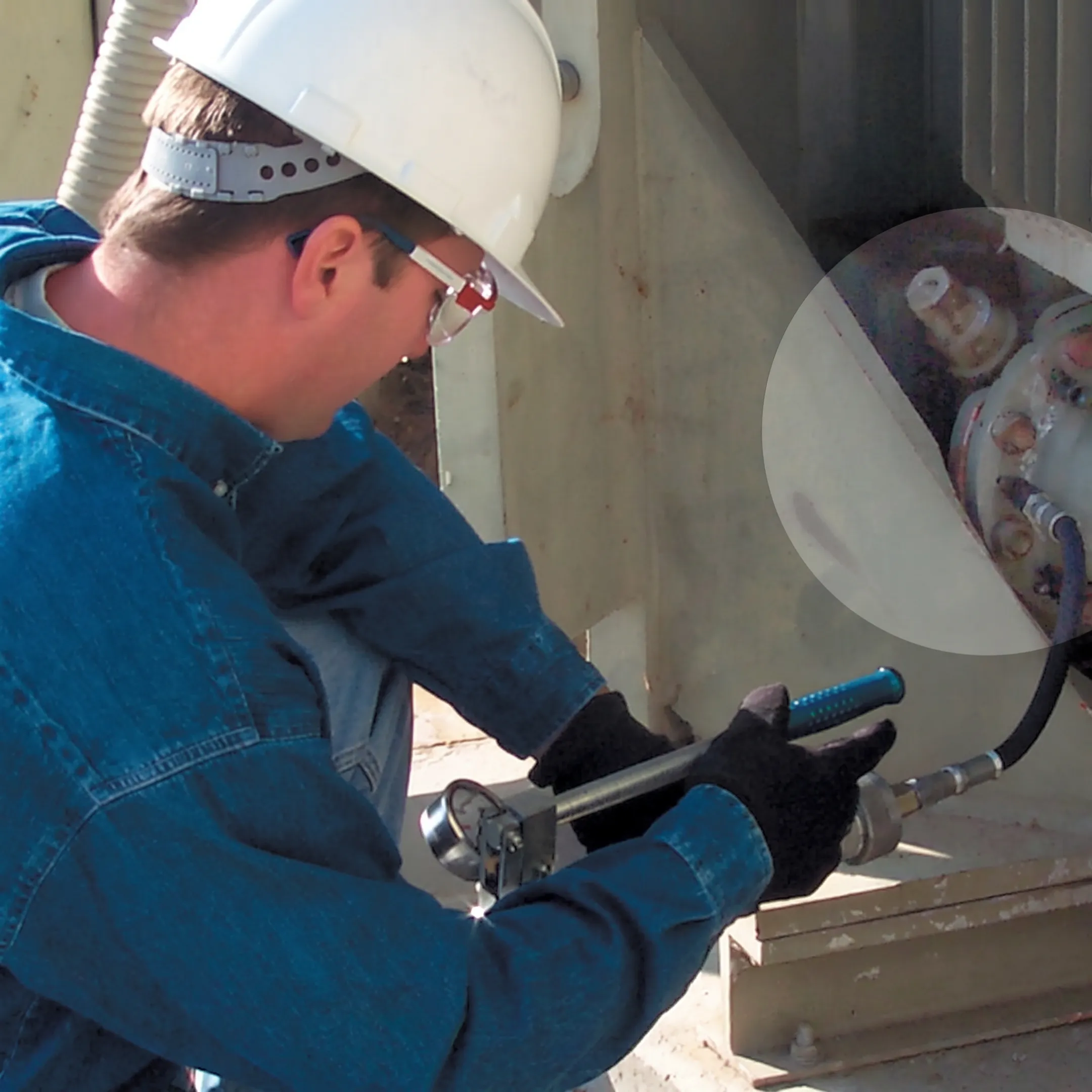 Technician applying a sealing solution to substation equipment