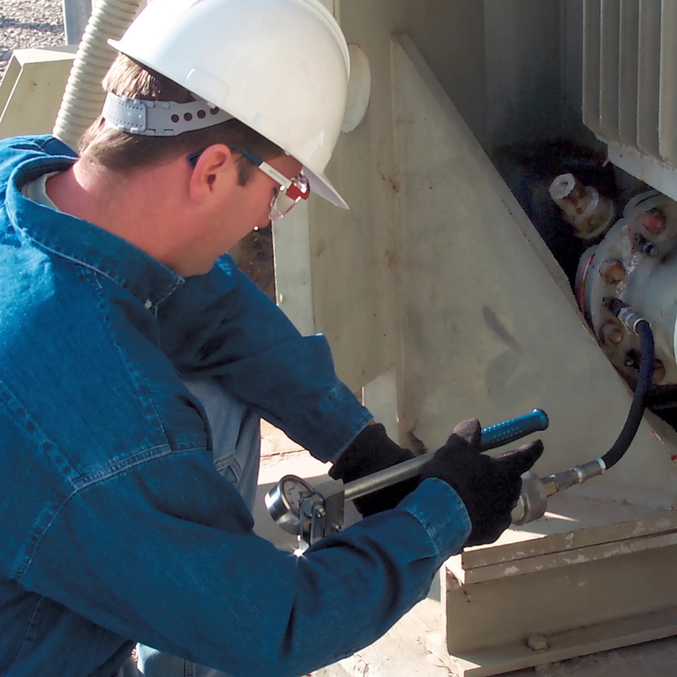 Technician sealing an oil leak on a transformer