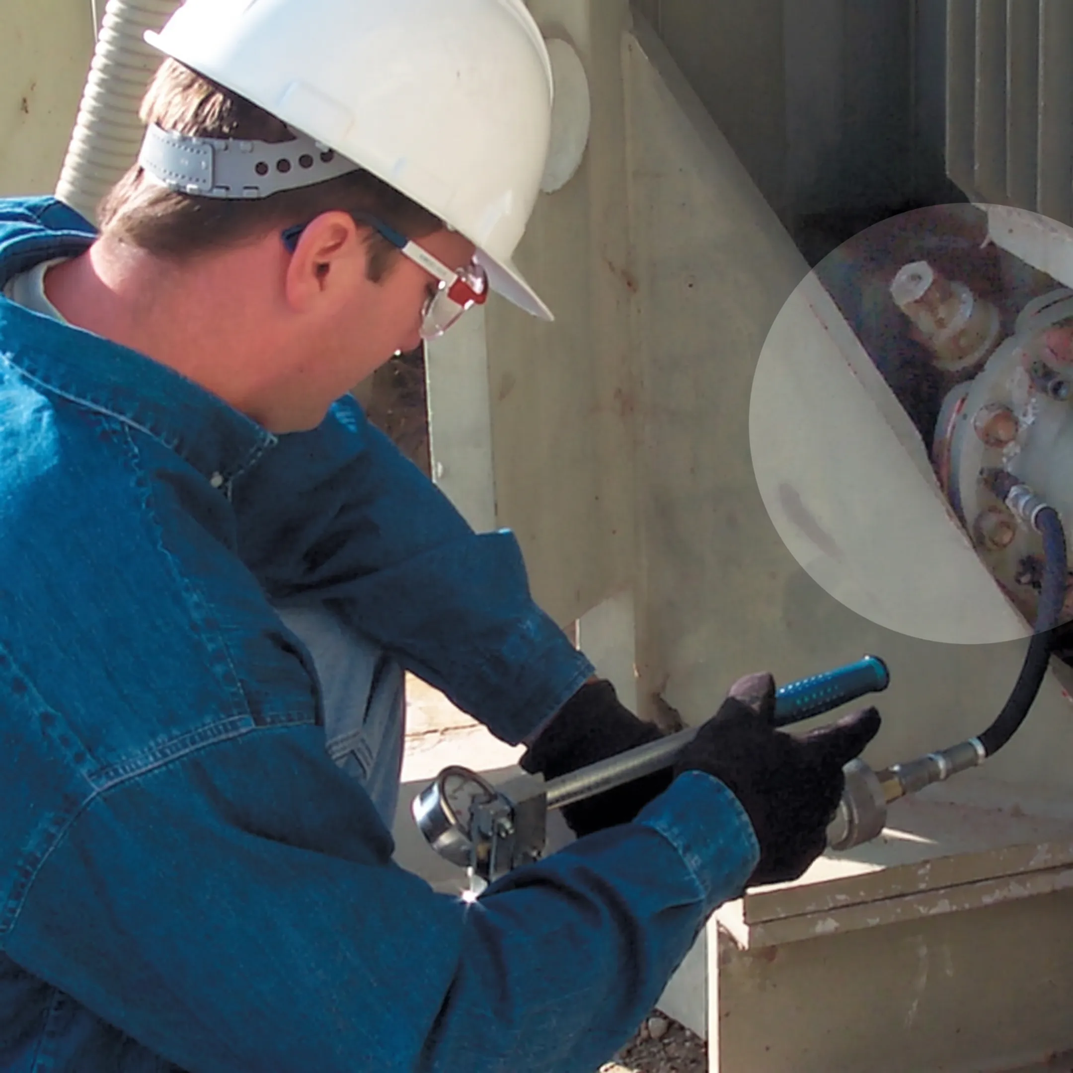Technician applying a sealant repair to a transformer leak