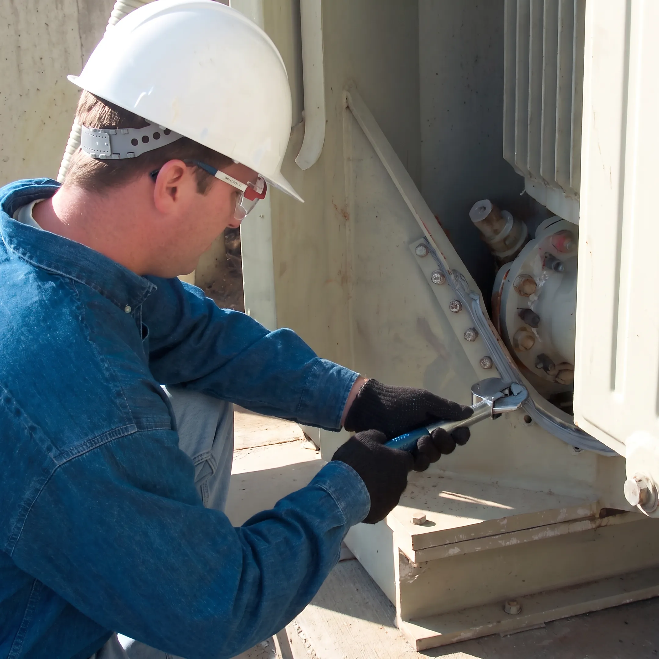 Technician sealing a transformer lid gasket leak
