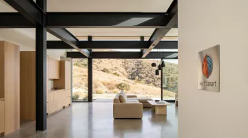 Luxury steel frame home interior with polished concrete floors exposed steel beams and level-5 drywall finishes