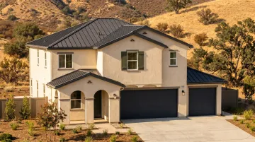 Wildfire-resistant home with non-combustible cladding ember-resistant vents and metal roofing