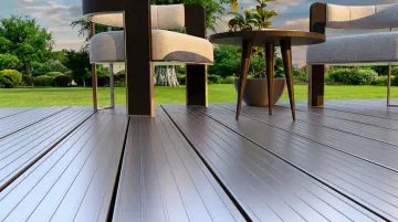 Aluminum and concrete deck surface materials installed on modern outdoor deck