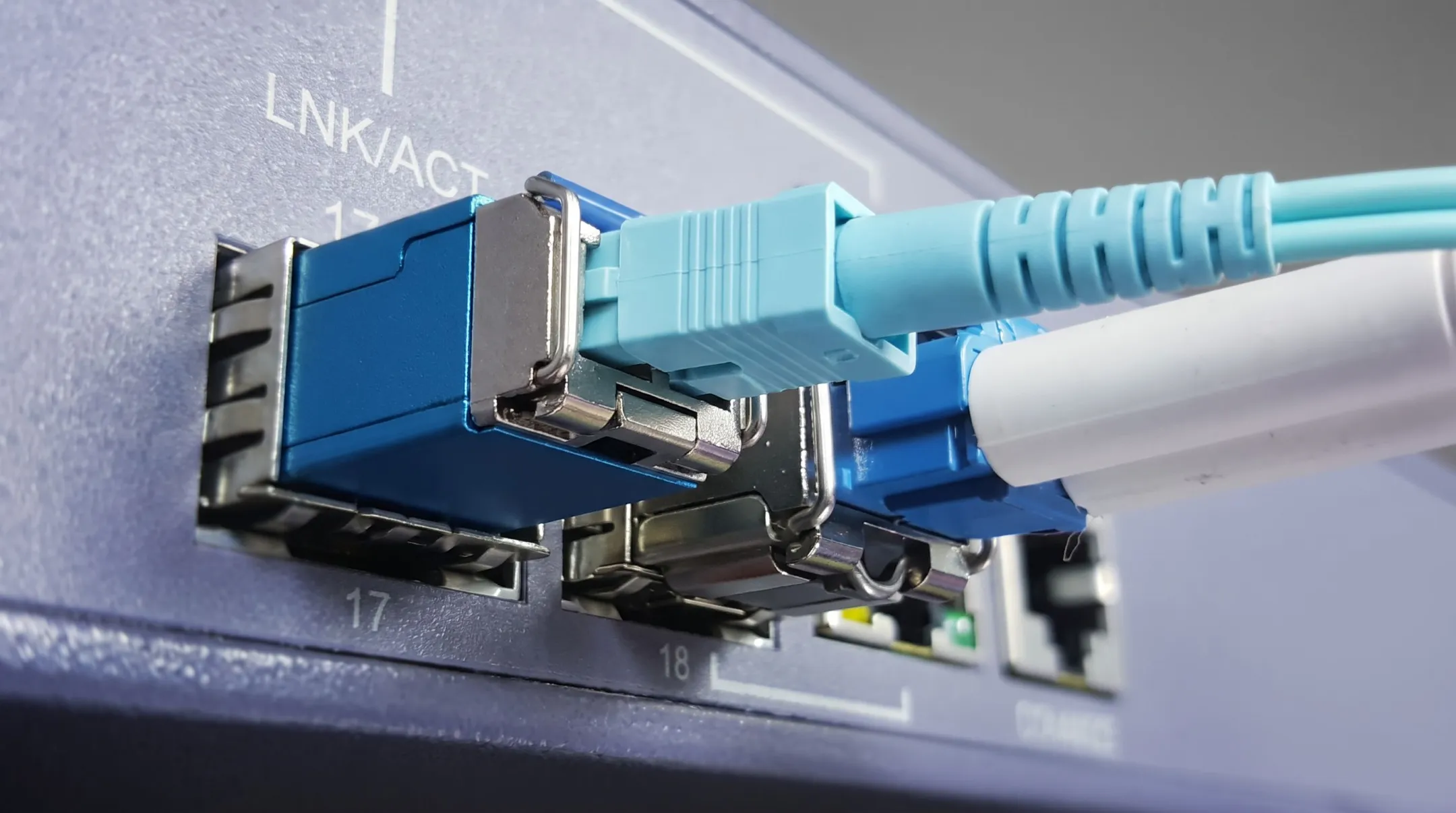 SFP transceiver module inserted into network switch port with LC fiber connector