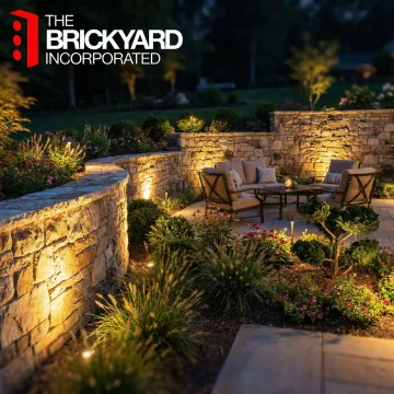 Low voltage landscape lights accenting a stone patio and garden bed at night