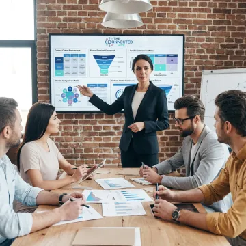 Consultant reviewing contact center strategy with executives