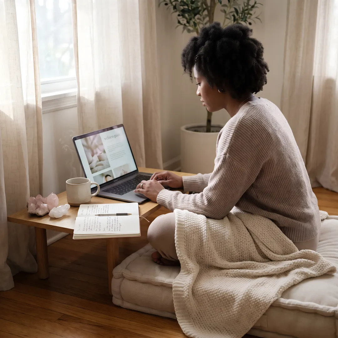 Woman exploring holistic healing resources on a laptop