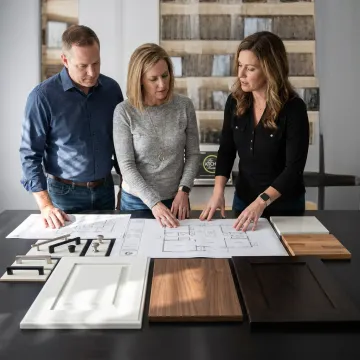 Designer reviewing kitchen plans and cabinet samples