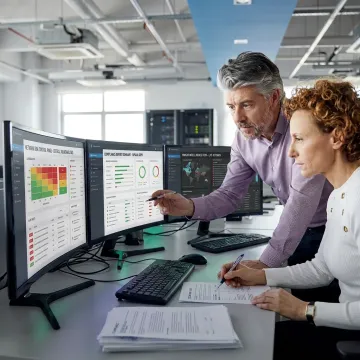 IT compliance and risk management team reviewing security systems