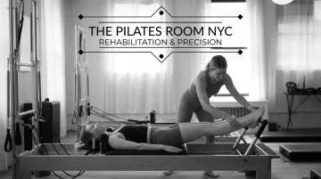 Client performing Reformer footwork exercise with instructor cuing knee alignment at Pilates studio