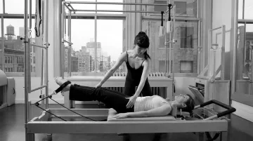 Pilates Room NYC instructor guiding private sciatica rehabilitation session on reformer