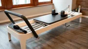 Pilates Reformer machine with spring resistance carriage footbar and straps