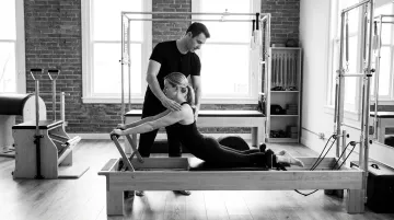 Classical Pilates Reformer apparatus session targeting posterior chain and hip stabilizers