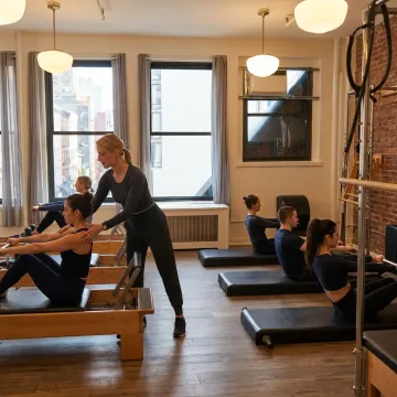 Small group Pilates class on reformers