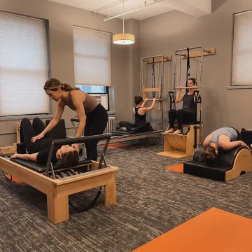 Small group Pilates class on reformers