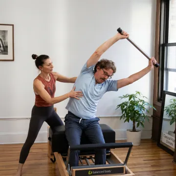 Instructor guiding a Reformer Pilates session