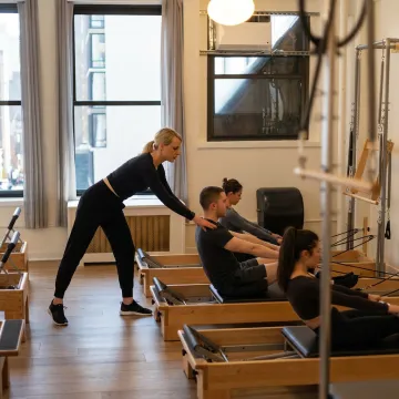 Semi-private Reformer Pilates class in a boutique studio