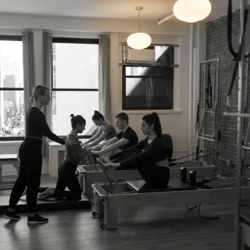 Reformer Pilates class in a boutique studio