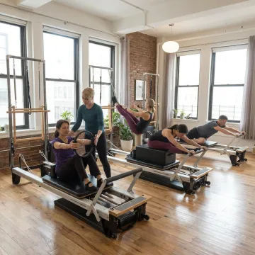 Instructor leading a focused mat Pilates class