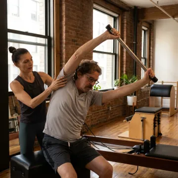 Beginner Pilates student learning on a Reformer