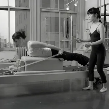 Athlete training on Pilates reformer