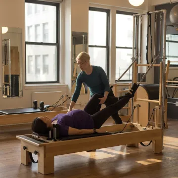 Instructor guiding prenatal Pilates