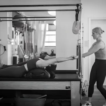 Athlete training on Pilates reformer